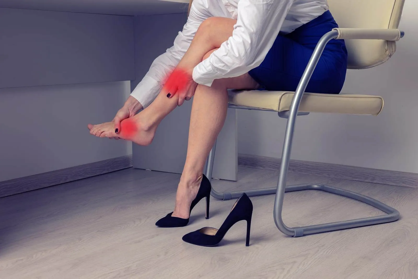 young-woman-suffering-from-leg-pain-in-office-because-of- Plantar Fasciitis